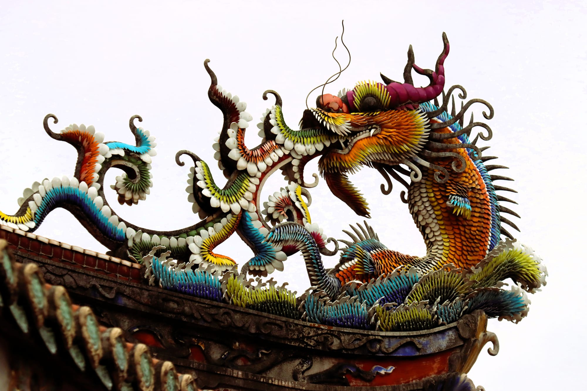 A colorful dragon on a roof on a circular position